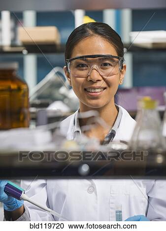 Stock Image - Japanese scientist working in laboratory. Fotosearch