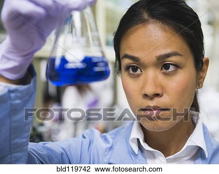 Stock Image - Japanese scientist working in laboratory. Fotosearch