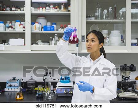 Stock Image - Japanese scientist working in laboratory. Fotosearch