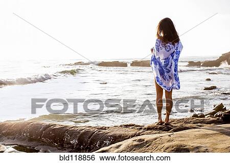 Stock Photograph - Japanese woman standing on beach. Fotosearch