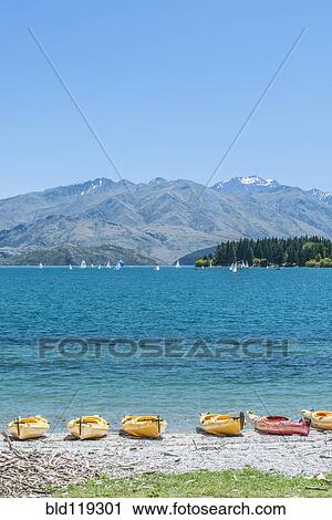 Kayaks docked along beach, Lake Wanaka, Otago, New Zealand View Large Photo Image Stock Image - Kayaks docked along beach, Lake Wanaka, Otago, New Zealand. Fotosearch
