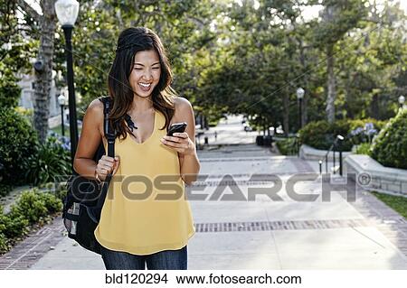 Picture - Korean student smiling on campus. Fotosearch