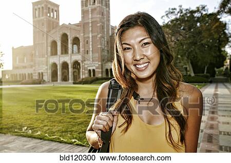 Stock Image - Korean student smiling on campus. Fotosearch