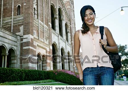 Stock Image - Korean student smiling on campus. Fotosearch