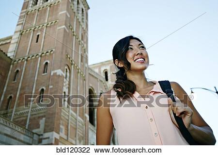 Stock Image - Korean student smiling on campus. Fotosearch