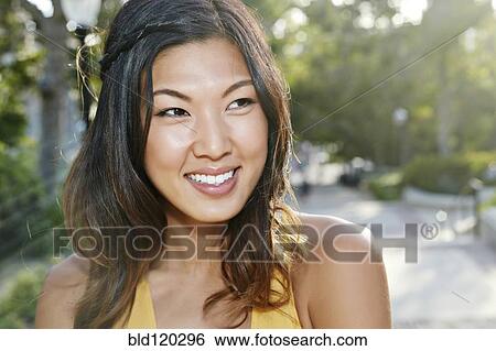 Stock Photograph - Korean student smiling on campus. Fotosearch
