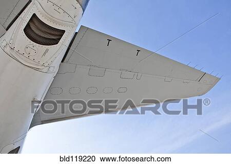 Low angle view of airplane wing against blue sky View Large Photo Image Stock Image - Low angle view of airplane wing against blue sky. Fotosearch