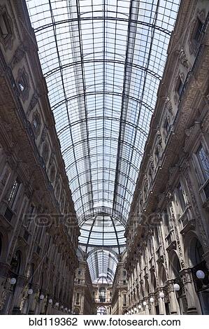 Stock Image - Low angle view of ornate glass ceiling. Fotosearch
