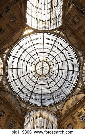 Stock Image - Low angle view of ornate glass ceiling. Fotosearch