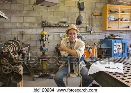 Picture - Middle Eastern man working in workshop. Fotosearch