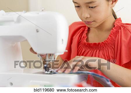 Mixed race girl using sewing machine View Large Photo Image Stock Image - Mixed race girl using sewing machine. Fotosearch