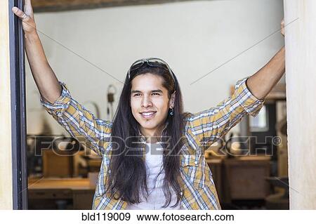 Stock Photo - Mixed race man standing in doorway. Fotosearch