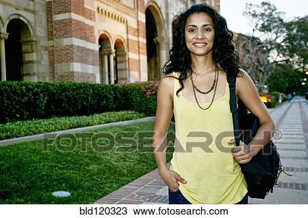 Stock Image - Mixed race student smiling on campus. Fotosearch