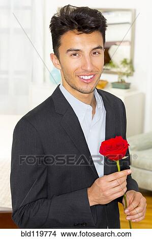 Mixed race teenager holding rose View Large Photo Image Picture - Mixed race teenager holding rose. Fotosearch