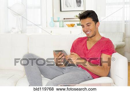 Stock Photo - Mixed race teenager using digital tablet. Fotosearch