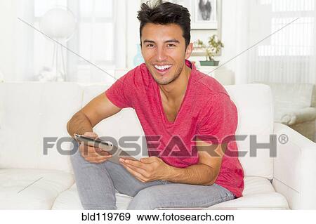Stock Photo - Mixed race teenager using digital tablet. Fotosearch
