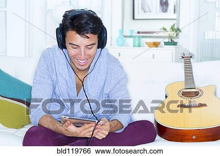 Stock Photograph - Mixed race teenager using digital tablet. Fotosearch