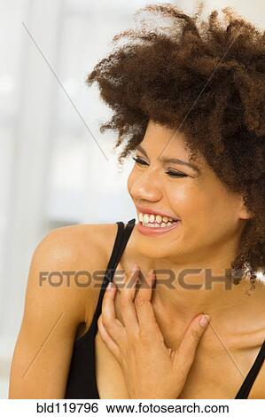 Stock Photograph - Mixed race woman laughing. Fotosearch