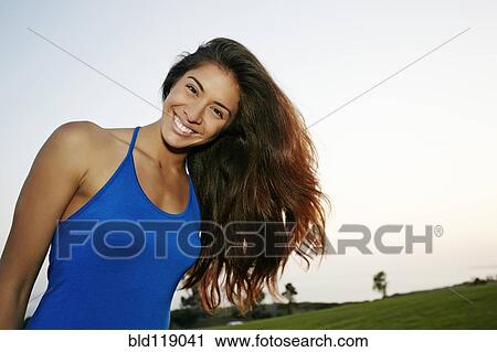 Mixed race woman smiling in park View Large Photo Image Stock Image - Mixed race woman smiling in park. Fotosearch