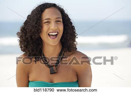 Mixed race woman smiling on beach View Large Photo Image Stock Image - Mixed race woman smiling on beach. Fotosearch