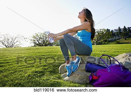 Mixed race woman wearing workout gear in park View Large Photo Image Stock Photograph - Mixed race woman wearing workout gear in park. Fotosearch