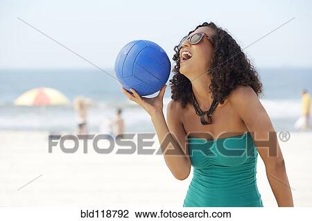 Mixed race woman with volleyball on beach View Large Photo Image Stock Image - Mixed race woman with volleyball on beach. Fotosearch