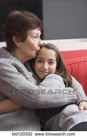 Older Hispanic woman hugging granddaughter View Large Photo Image Stock Image - Older Hispanic woman hugging granddaughter. Fotosearch