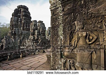 Stock Image - Ornate stone carvings on walls, Angkor, Cambodia. Fotosearch