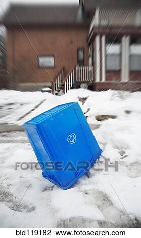Stock Image - Overturned recycling box in snow. Fotosearch