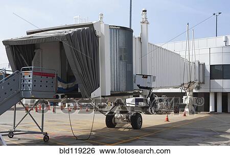 Passenger boarding bridge on runway View Large Photo Image Stock Photograph - Passenger boarding bridge on runway. Fotosearch