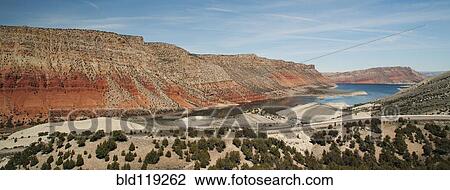 Stock Image - Road along lake and rock formations. Fotosearch