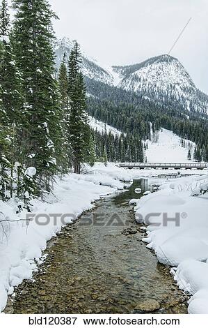 Stock Photo - Rocky creek in snowy rural landscape. Fotosearch