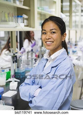 Stock Image - Scientist smiling in laboratory. Fotosearch