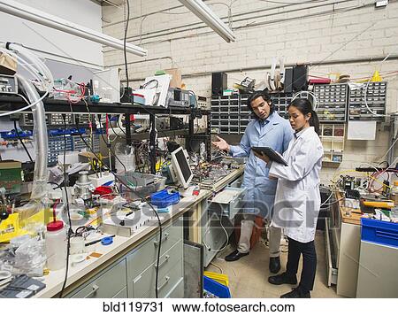 Stock Image - Scientists working in laboratory. Fotosearch