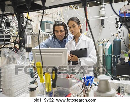 Stock Image - Scientists working in laboratory. Fotosearch