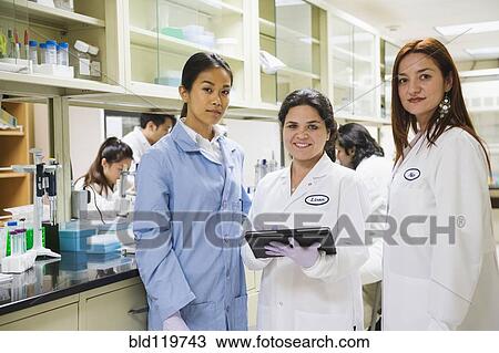Stock Image - Scientists working in laboratory. Fotosearch