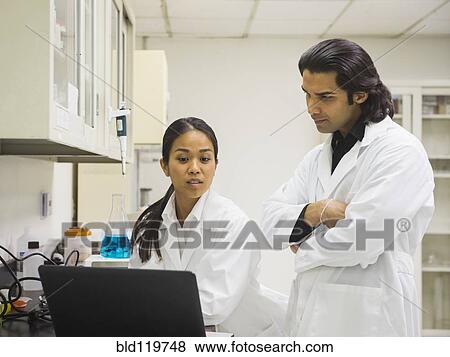 Stock Photo - Scientists working in laboratory. Fotosearch