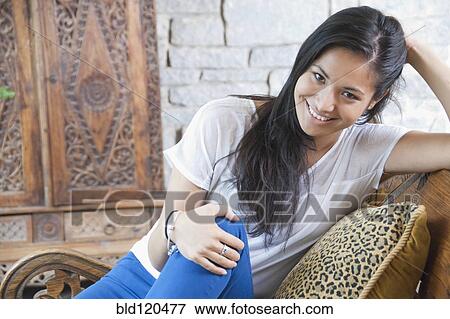 Stock Photo - Smiling woman relaxing in chair. Fotosearch