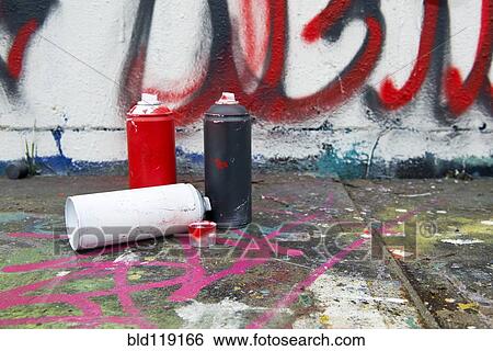 Stock Photograph - Spray paint cans by graffiti wall. Fotosearch
