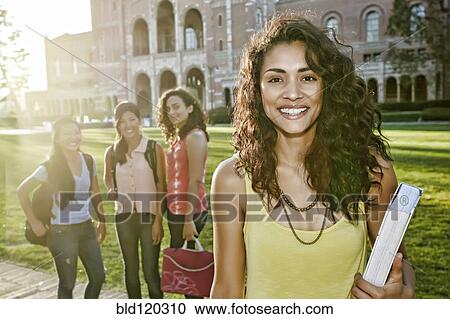Stock Image - Student smiling on campus. Fotosearch