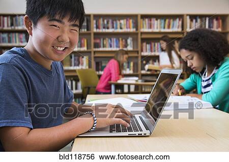 Student using laptop in library View Large Photo Image Stock Photograph - Student using laptop in library. Fotosearch
