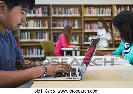 Student using laptop in library View Large Photo Image Stock Photography - Student using laptop in library. Fotosearch