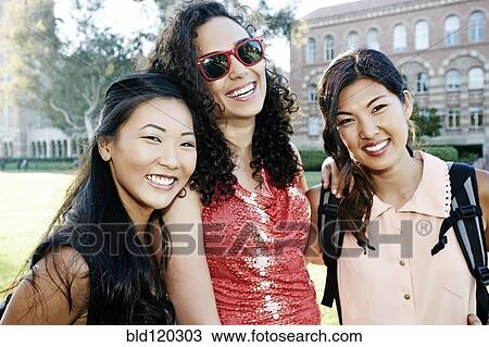 Stock Image - Students smiling on campus. Fotosearch