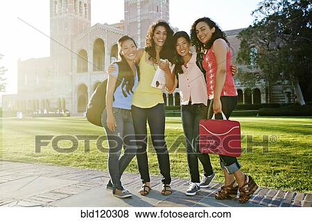 Students smiling together on campus View Large Photo Image Stock Photo - Students smiling together on campus. Fotosearch