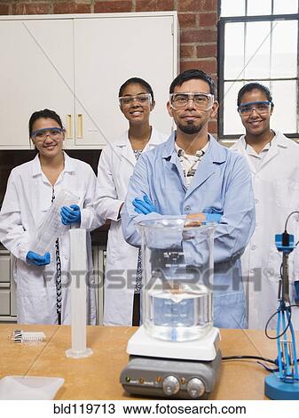Teacher and students smiling in science lab View Large Photo Image Stock Image - Teacher and students smiling in science lab. Fotosearch