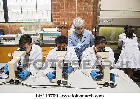 Stock Photo - Teacher and students working in science lab. Fotosearch