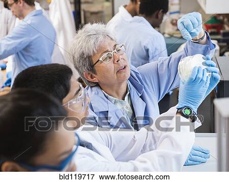 Stock Photo - Teacher and students working in science lab. Fotosearch
