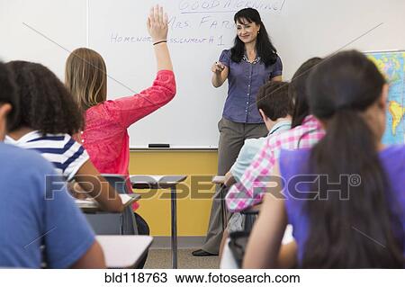 Stock Image - Teacher calling on student in class. Fotosearch