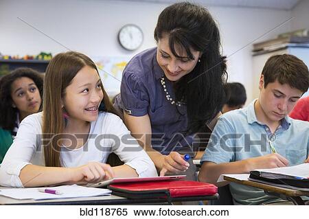 Teacher helping students in class View Large Photo Image Stock Photography - Teacher helping students in class. Fotosearch