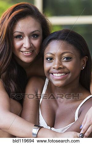 Picture - Teenage girls smiling outdoors. Fotosearch